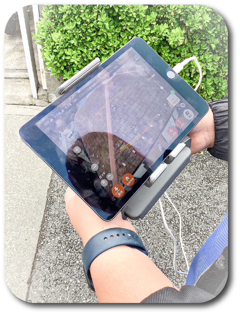 タブレットで屋根の状況を確認する様子